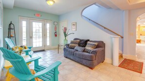 A living room with teal chairs, a grey sofa, and a staircase leading to another level. - Spacious Yellowstone River Retreat w/ Trails! (Emigrant)
