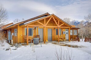 A wooden lodge with a large porch, multiple doors, and a view of snow-covered mountains. - 6 Mi to Chico Hot Springs: Villa w/ River Access (Emigrant)