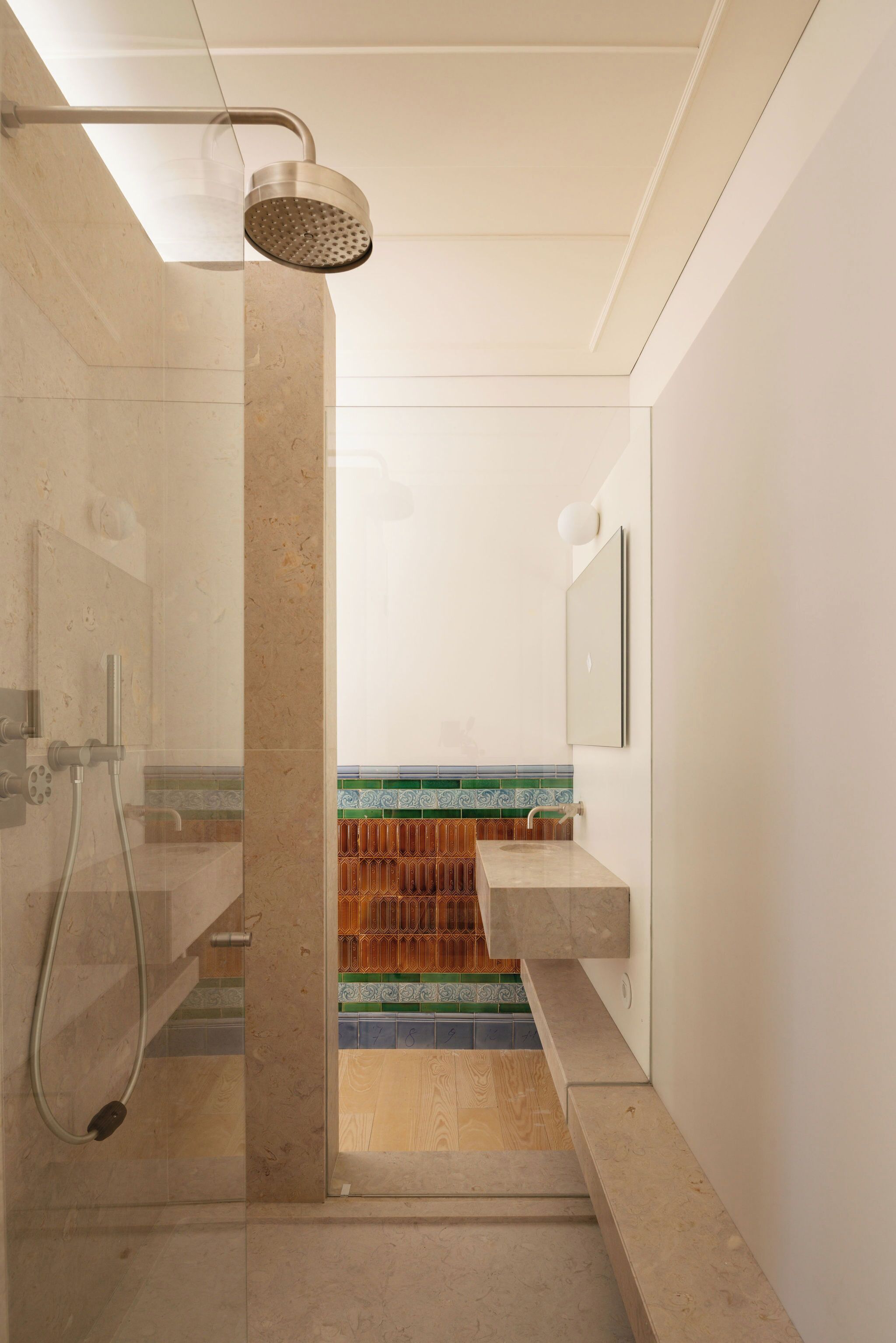 Ein modernes Badezimmer mit Dusche, Waschbecken und Spiegel.