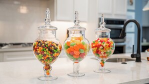 Three glass jars filled with colorful candies on a kitchen counter. - The Bella Muse - 3-Bedroom House W/ Hot Tub close to Bike Trails (Bella Vista)