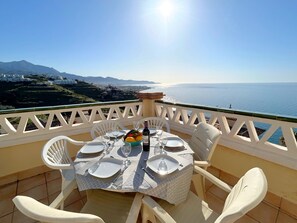 A table set for four with a view of the sea and mountains in the background. - New Property - Big Terrace with Great Sea Views and Mountain Views - Alcazaba 33 in Nerja (Torrox)