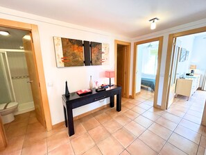 A hotel room with a tiled floor, a desk with a lamp, and artwork on the wall. - New Property - Big Terrace with Great Sea Views and Mountain Views - Alcazaba 33 in Nerja (Torrox)
