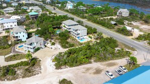 An aerial view of a coastal residential area with houses, a road, and a beach. - 🧜The Gulf Club🧜 Beach Views | Private Pool | Walk to Beach (Cape San Blas)