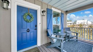 A porch with a blue door, a welcome mat, and two chairs. - ⭐Private Pool-4 Bikes-30A-Beach Access-Claddagh Cottage⭐ (Santa Rosa Beach)