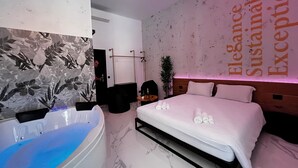 A modern hotel room with a large bed, a bathtub, and a wall with the words "Elegance Sustainable Exceptional" visible. - ESE luxury spa suites (Rome)