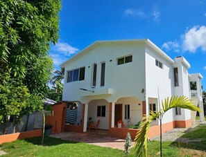 Enjoy a peaceful stay in this two-story home surrounded by a lush lawn and trees.