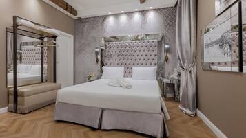 A bedroom with a large bed, a mirror, and a vanity.