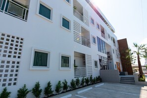 Stylish building with balconies, louvered windows, and a geometric design.