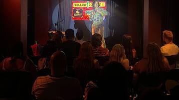 An indoor venue with a stage and audience.