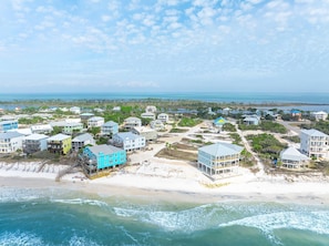 A coastal residential area with beachfront properties, including houses with balconies and a beach house with a pool. - The Gulf Club (Port St. Joe)