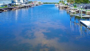 A marina with docked boats and waterfront houses. - Tidewater: Bring your boat, backyard beach,kayaks. (Hernando Beach)