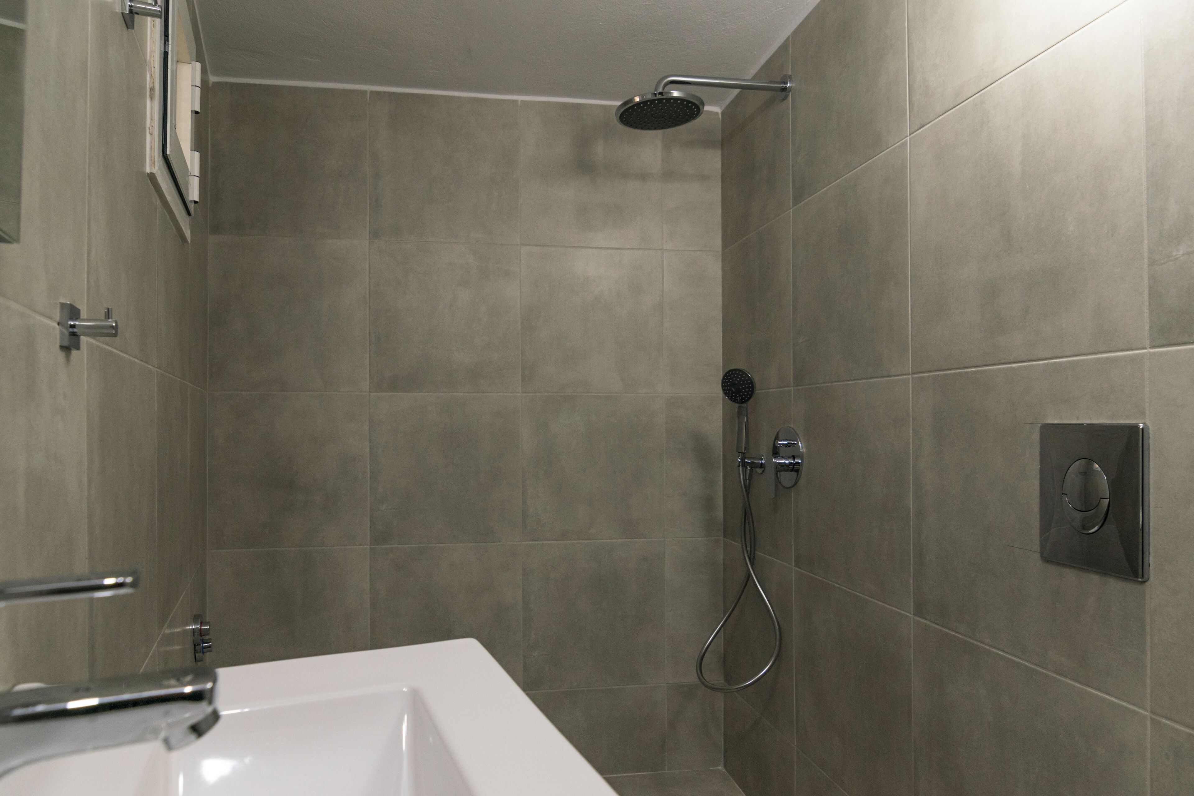 A modern bathroom with a shower, a bathtub, and a toilet.