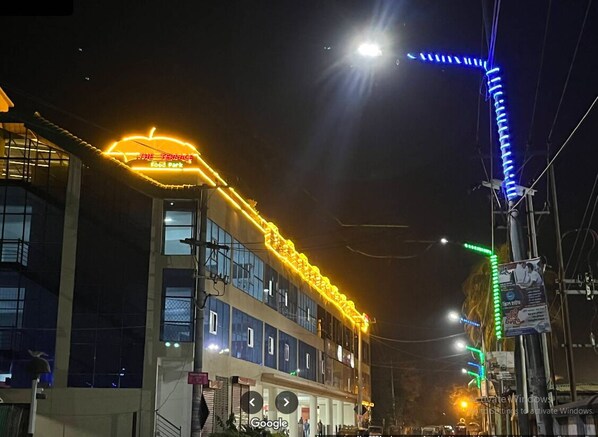 A building with a neon sign reading "The Penhurst Food Park" and a staircase leading to the entrance. - Hotel Air-Star (Saidpur)