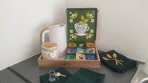 A wooden tray with a white teapot, a box of tea, and a set of keys. - Richmond Retreat A Gem! (Richmond)