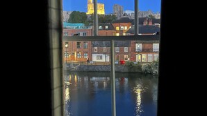 A view through a window with a clear reflection of a cityscape, including a prominent cathedral and surrounding buildings. - Windsor Castle panoramic views. Stay in the heart of Royal history (Eton)