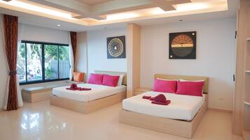 A modern hotel room with two beds, large windows, and artwork on the walls.