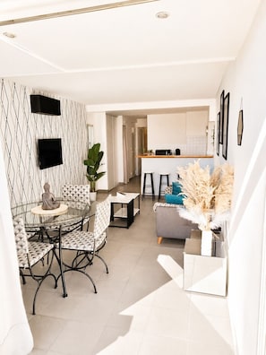 A modern interior with a dining area, kitchen, and living space.
