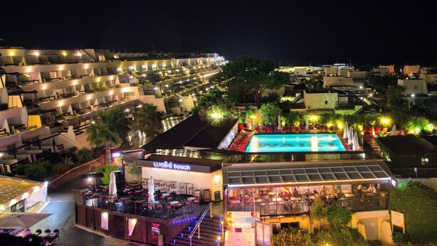 A hotel with a pool area, outdoor seating, and a bar/lounge area. - Naturiste Cap d'Agde Port Nature 854 (Agde)