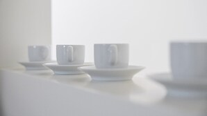 Three white cups on saucers on a white surface. - GuestReady - Souto Downtown Studio 1 (Porto)