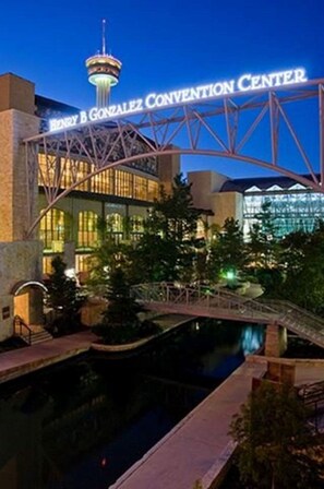 The Henry B. Gonzalez Convention Center with a prominent tower and a bridge leading to the building.