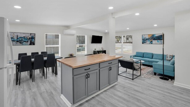 A modern apartment with a kitchen, dining area, and living room.