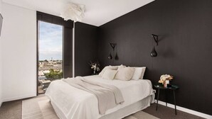 A modern bedroom with a large bed, a view of the city, and a balcony. - Whow! Unique Quirky Spacious Free Off Street Park (Christchurch)
