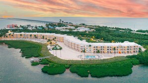 A resort with multiple buildings, a swimming pool, and a bridge connecting to the mainland. - Marathon Beachfront | ADA 2 Queens + Veranda (Marathon)