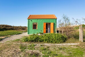 Stroll through the charming single-story building with a red-tiled roof and enjoy the serene surroundings.