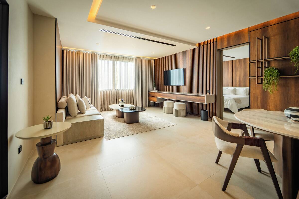 A modern living room with a sofa, coffee table, and TV.