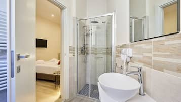 Habitació triple Deluxe, no fumadors, vistes a la ciutat | Bany | Dutxa, assecador de cabells, sabatilles i tovalloles