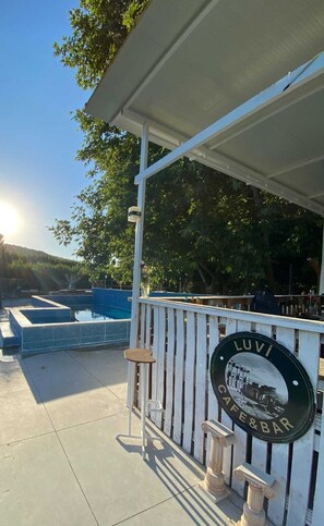 Seasonal outdoor pool, open 8:30 AM to 9:00 PM, pool umbrellas