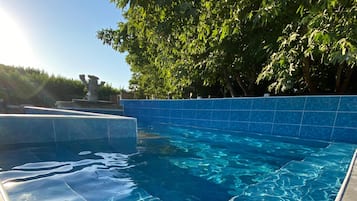 Seasonal outdoor pool, open 8:30 AM to 9:00 PM, pool umbrellas