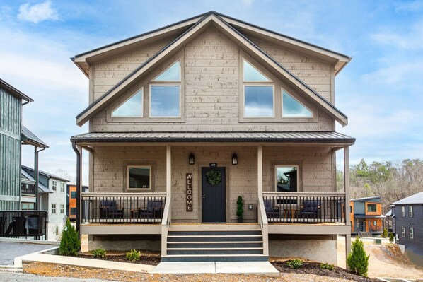A two-story house with a front porch, a black front door, and a number "417" on the door. - Twilight Mist Getaway | Pool, Hot Tub + Game Room! (Pigeon Forge)