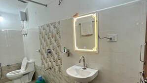 A bathroom with a toilet, sink, and shower. - Home in the Jungle (Kurai)