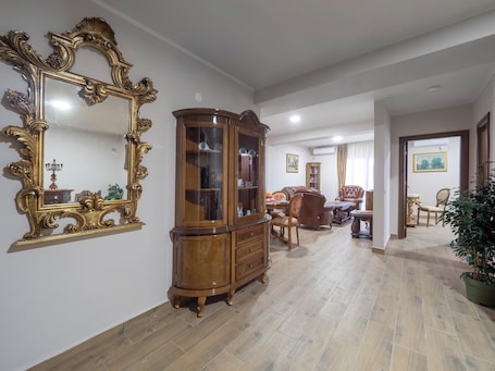 Deluxe One Bedroom Apartment | Living area | 40-inch Smart TV with satellite channels