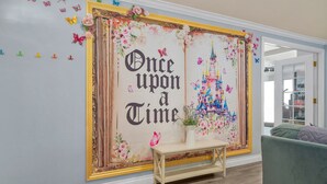 Een muur met een grote poster waarop een kasteel staat afgebeeld en de tekst 'Once upon a Time' staat.
