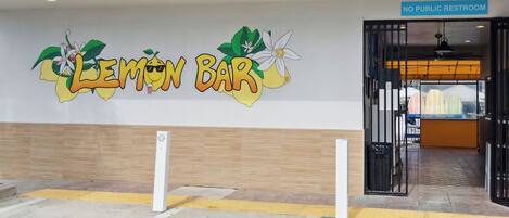 The exterior of a Lemon Bar with a 'No Public Restroom' sign.