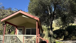 A small, single-story cabin with a porch and a covered deck area. - Cottage, Sleeps 4 - Scenic Cottage, 1 Bedroom, Sleeps 4 (Winters)