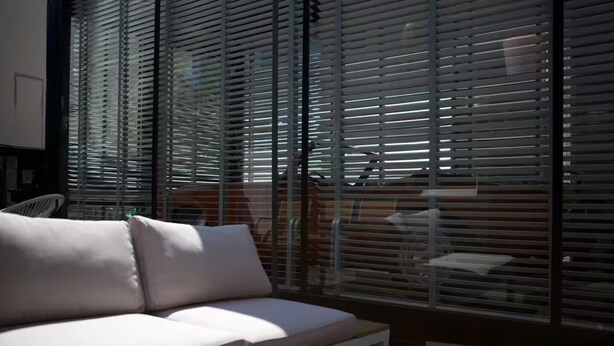 A modern living room with a white sofa and a dining table. - The Room 44 (Hamburg)