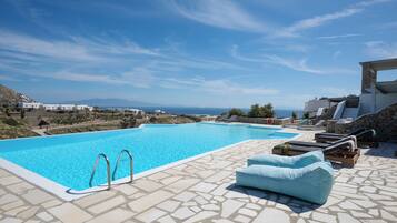 Relax by the pool surrounded by scenic views of the sea and distant mountains.