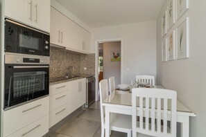 Enjoy meals in this kitchen with a Bosch oven, granite countertop, and dining area.