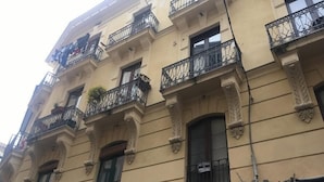 A multi-story building with balconies, decorative moldings, and a sign that reads "VENDESI". - L'Incanto House (Salerno)