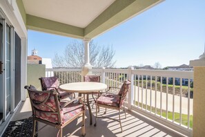 Enjoy a peaceful moment on this balcony with a view of the surrounding residential area.