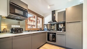 A modern kitchen with a Bosch microwave, a built-in oven, and a stainless steel refrigerator. - Fyndor - Apartment located in center of Morzine (Morzine)
