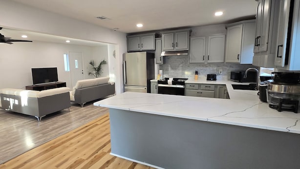 A modern kitchen with grey cabinets, a white countertop, and a built-in oven. - Perdido Key Beach !!!  Spacious 3/2, kid-pet friendly, boatramp, kids park=5min (Pensacola)
