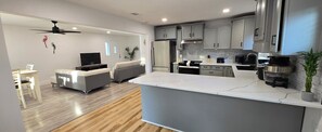 A modern kitchen with grey cabinets, a white countertop, and a built-in oven. - Perdido Key Beach !!!  Spacious 3/2, kid-pet friendly, boatramp, kids park=5min (Pensacola)