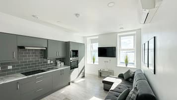 Sea View 1 Bedroom Apartment | Living area | 65-inch Smart TV with satellite channels