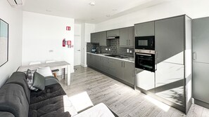 Sea View 1 Bedroom Apartment | Living area | 65-inch Smart TV with satellite channels