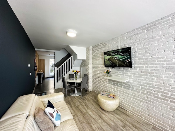 Design Townhome | Living area | 65-inch Smart TV with satellite channels