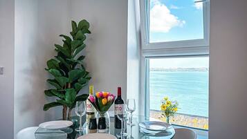 Stunning Harbour View 2 Bedroom Apartment | Living area | 65-inch Smart TV with satellite channels